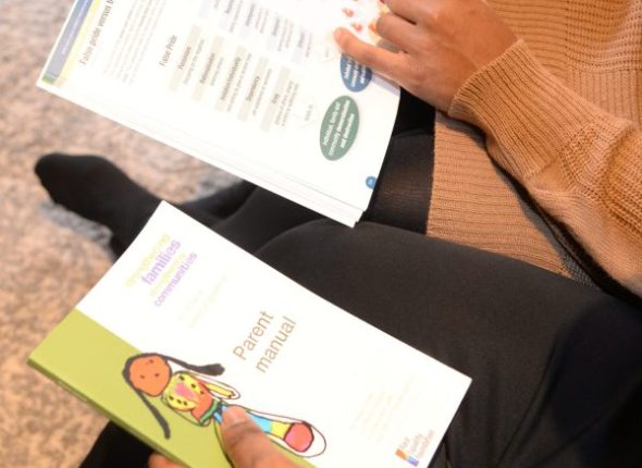 SFSC manuals in the laps of two people reading them